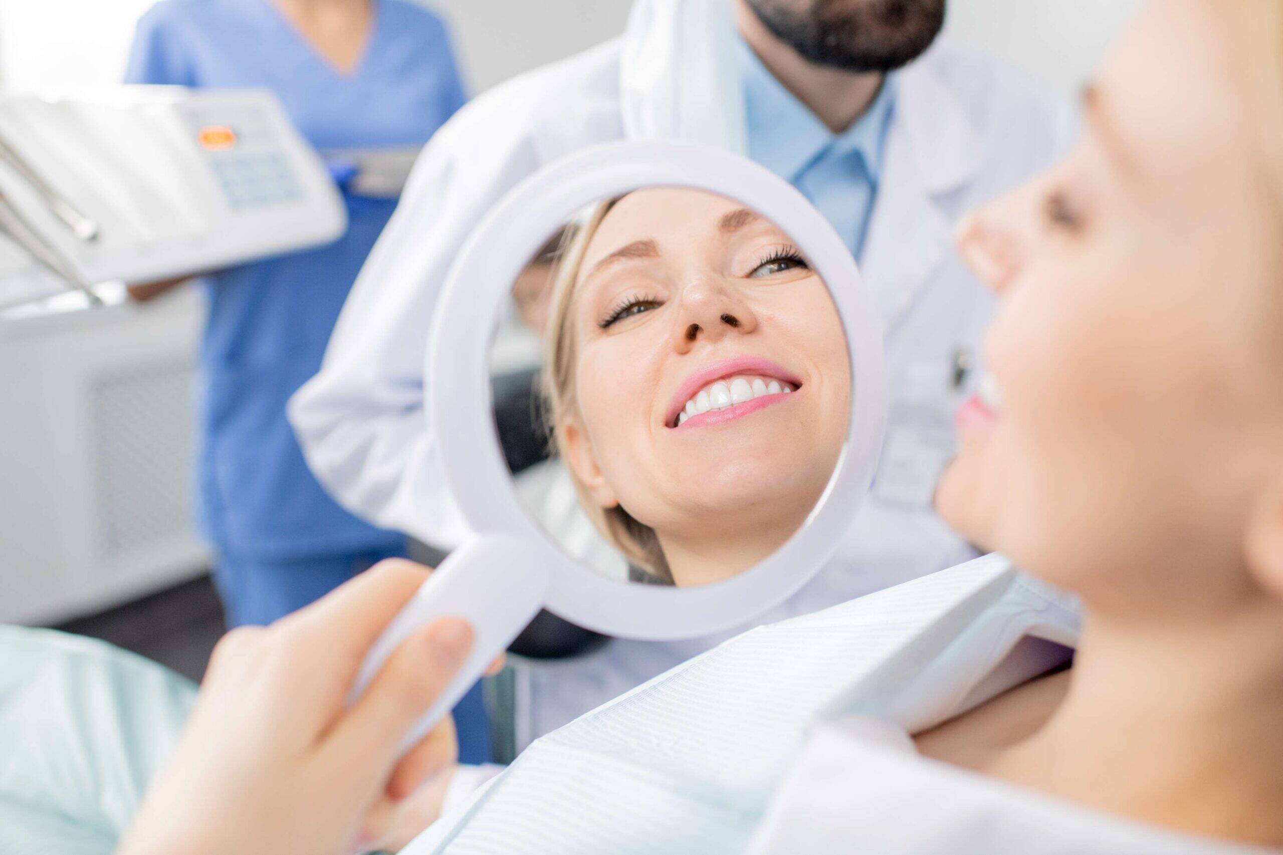 Patient viewing her smile in a mirror.
