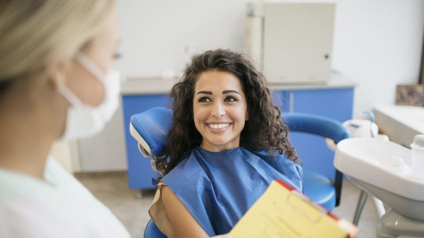 A Beautiful Lady Sitting On Dental Chair Is Excited For Her Dental Treatments