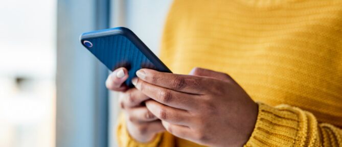 Woman checking Smile Exchange reviews on her mobile phone